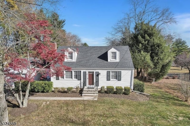 cape cod house with a shingled roof and a front yard