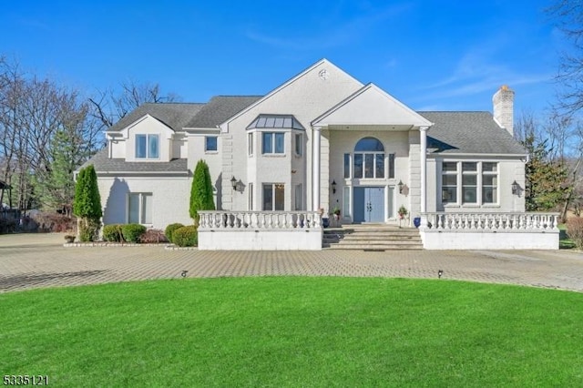 view of front of property with a chimney and a front yard