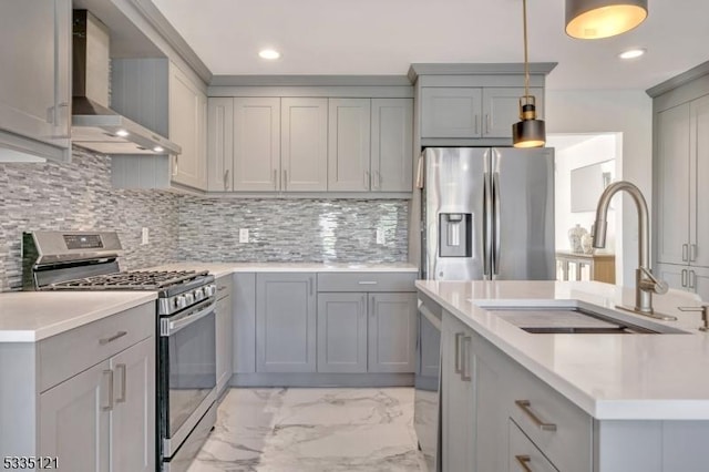 kitchen with wall chimney exhaust hood, appliances with stainless steel finishes, marble finish floor, gray cabinetry, and a sink