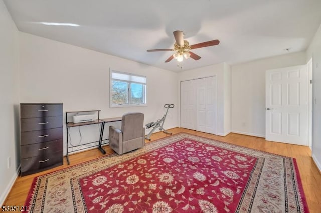 office with a ceiling fan, baseboards, and wood finished floors