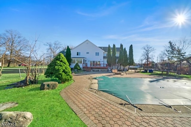 view of swimming pool featuring a fenced in pool, fence, and a lawn