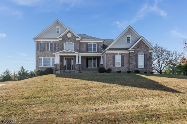 craftsman-style home with a front yard and covered porch