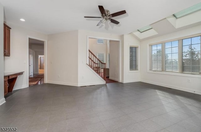 unfurnished living room featuring a ceiling fan, recessed lighting, baseboards, and stairs