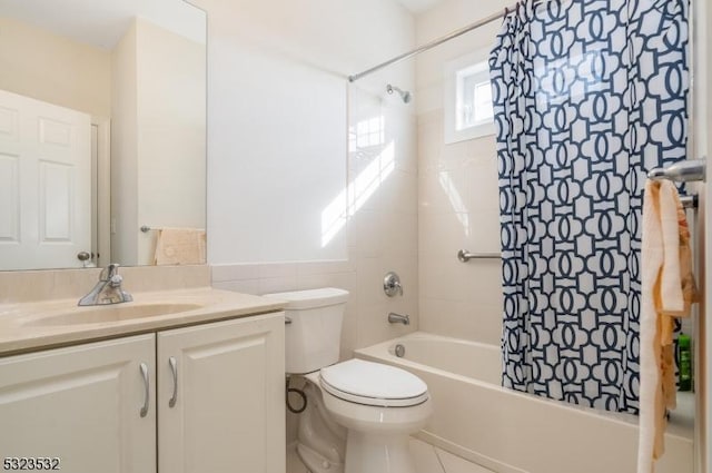 full bathroom with tile walls, vanity, toilet, and shower / bathtub combination with curtain