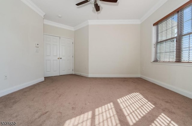 unfurnished bedroom with ornamental molding, a closet, carpet, and baseboards