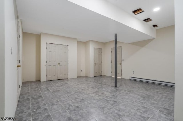 finished basement featuring baseboard heating and visible vents