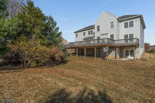 back of house featuring french doors, a yard, and a wooden deck