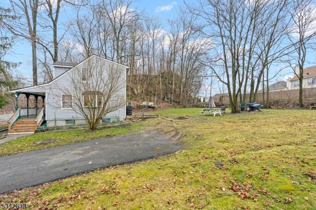 view of side of home featuring a lawn