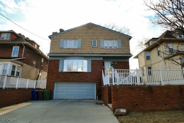 view of front of home with a garage, covered porch, brick siding, and driveway