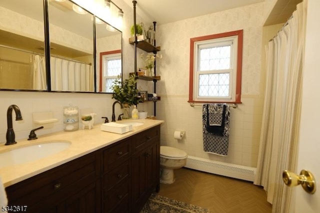 full bath featuring wallpapered walls, a baseboard radiator, plenty of natural light, and wainscoting