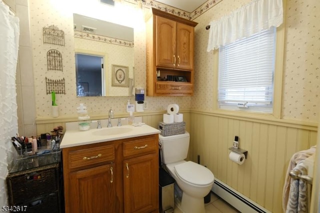 full bathroom featuring toilet, wallpapered walls, a baseboard heating unit, and wainscoting