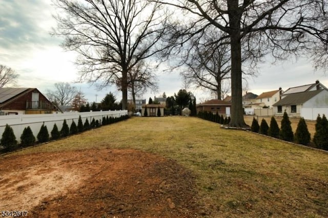 view of yard with a residential view and fence