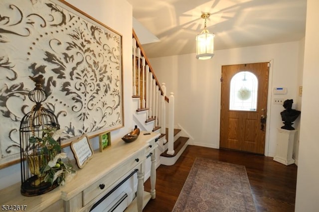 foyer with dark wood-style floors and stairway