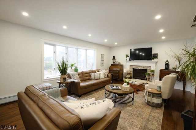 living area featuring recessed lighting, a fireplace, and wood finished floors