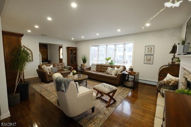 living room with a baseboard radiator, a fireplace, wood finished floors, and recessed lighting