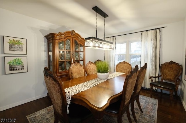 dining room with baseboards and wood finished floors