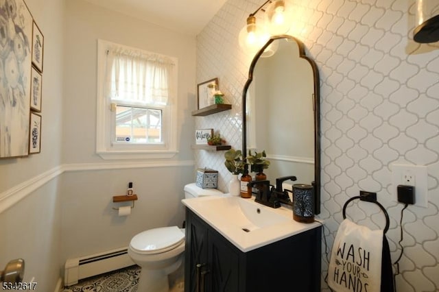 bathroom featuring baseboard heating, vanity, and toilet