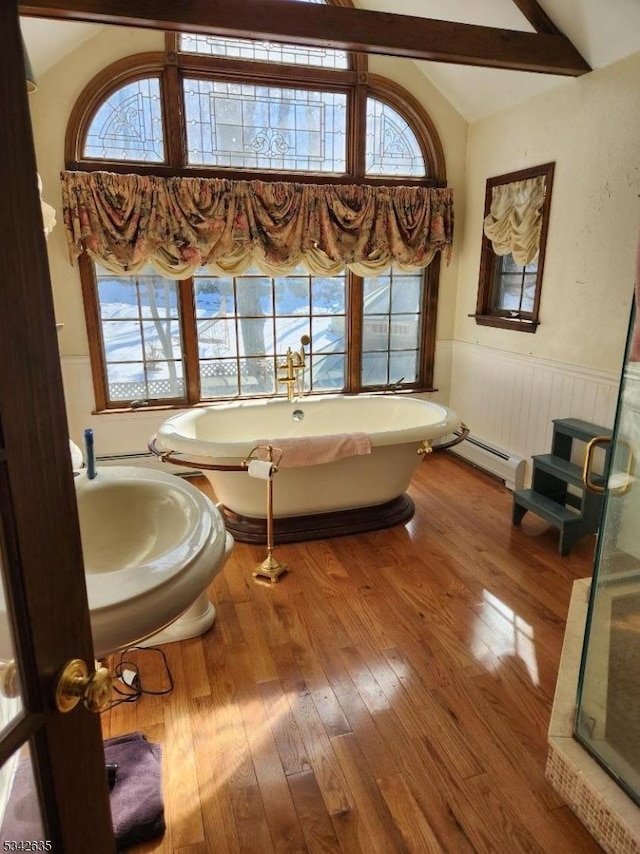 bathroom featuring lofted ceiling with beams, a wainscoted wall, wood-type flooring, and a baseboard radiator