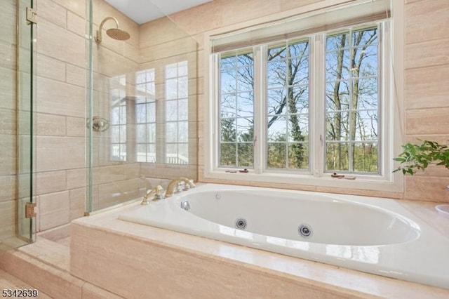 full bathroom featuring a jetted tub and a stall shower