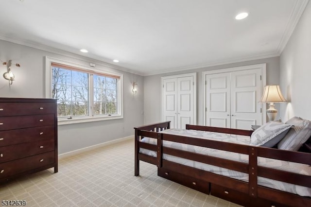 bedroom featuring multiple closets, ornamental molding, recessed lighting, baseboards, and light colored carpet