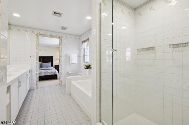 bathroom with tile patterned floors, visible vents, a stall shower, ensuite bath, and tile walls