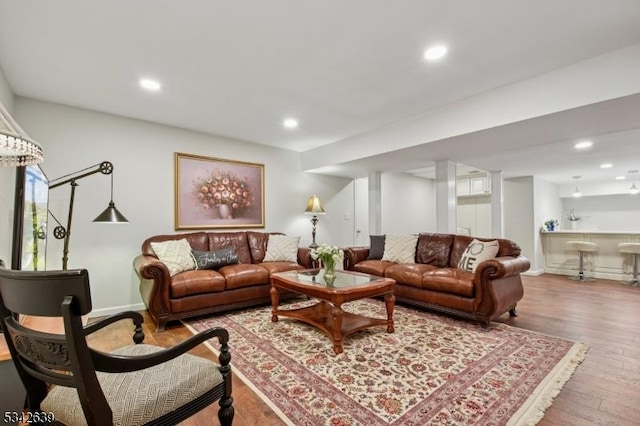 living room with recessed lighting, wood finished floors, and baseboards