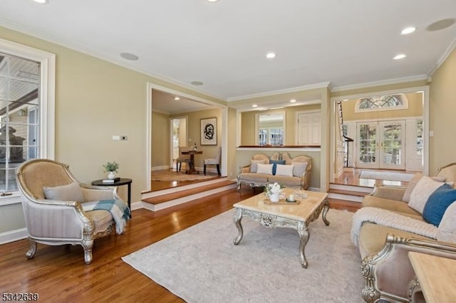 living area with ornamental molding, wood finished floors, recessed lighting, french doors, and baseboards