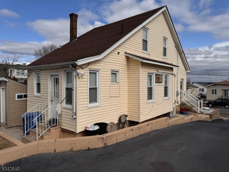 exterior space featuring entry steps and a chimney