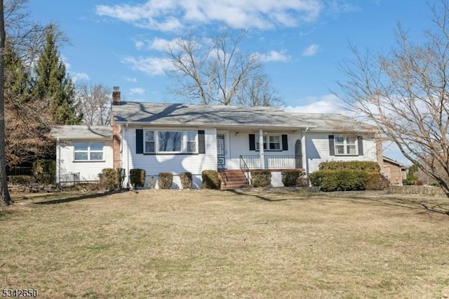 single story home with covered porch, a chimney, and a front lawn