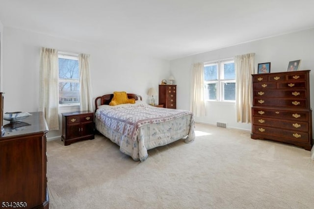 bedroom featuring light carpet and visible vents