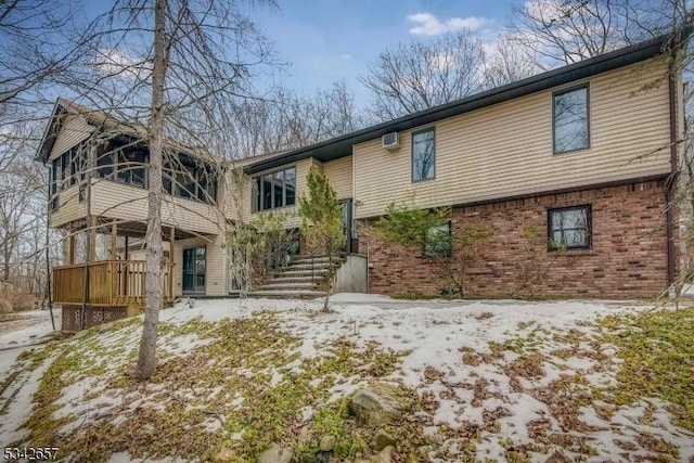 view of front of house with stairs and brick siding