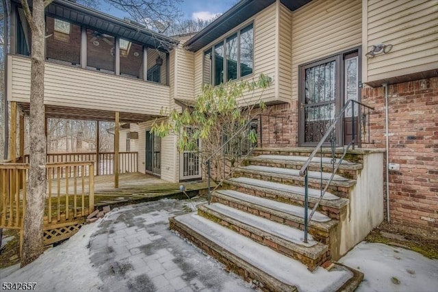 view of exterior entry featuring brick siding