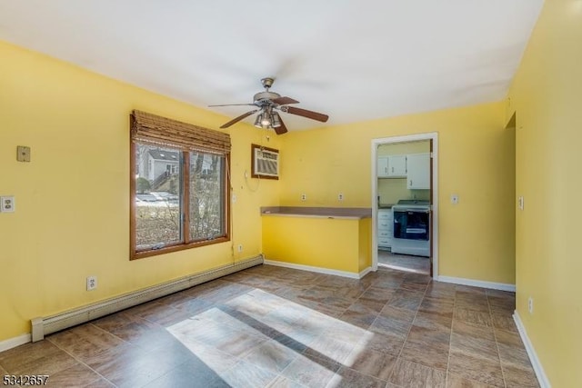 spare room with a ceiling fan, baseboards, baseboard heating, and a wall mounted AC