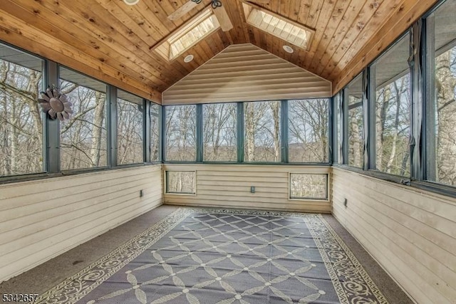 unfurnished sunroom featuring lofted ceiling with skylight and wood ceiling