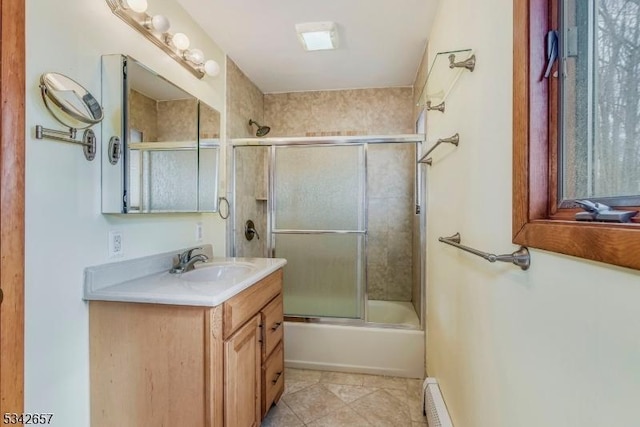 full bathroom featuring tile patterned flooring, enclosed tub / shower combo, vanity, and baseboard heating