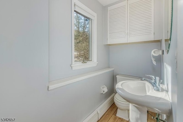 bathroom with toilet and wood finished floors