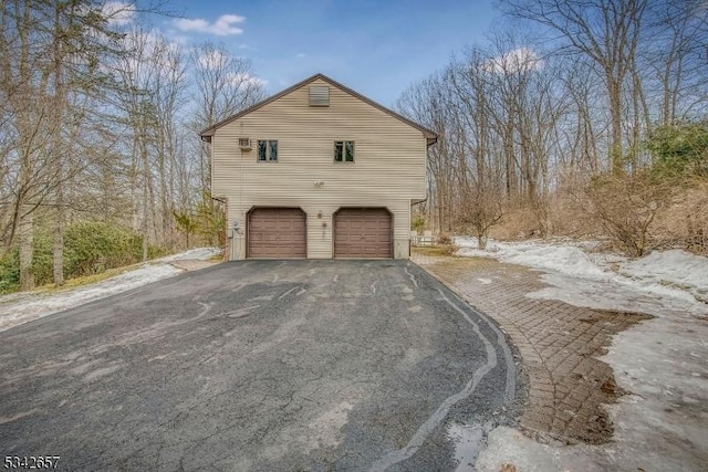 view of home's exterior with driveway and a garage