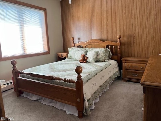 bedroom with light carpet and a baseboard radiator