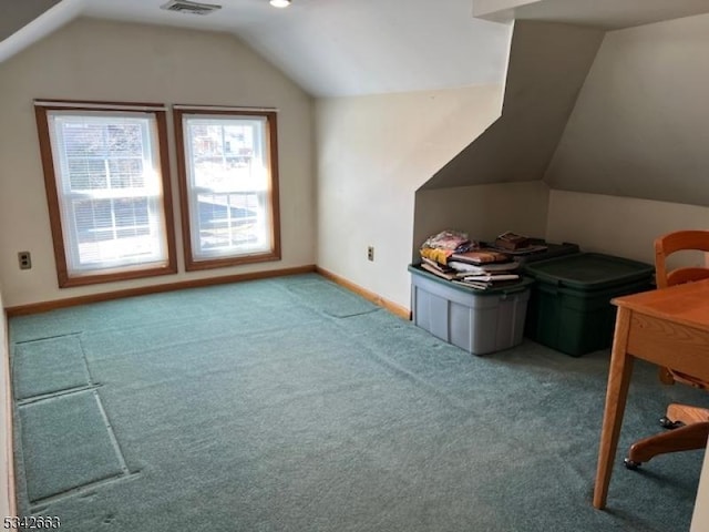 additional living space with lofted ceiling, carpet, visible vents, and baseboards