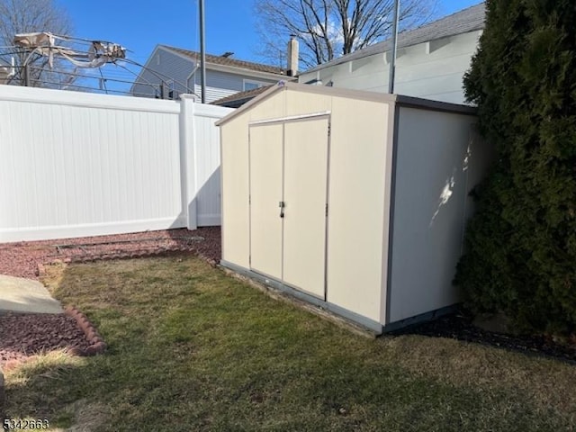 view of shed featuring fence