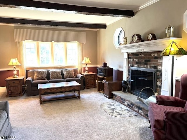 carpeted living room featuring ornamental molding, beamed ceiling, and a fireplace