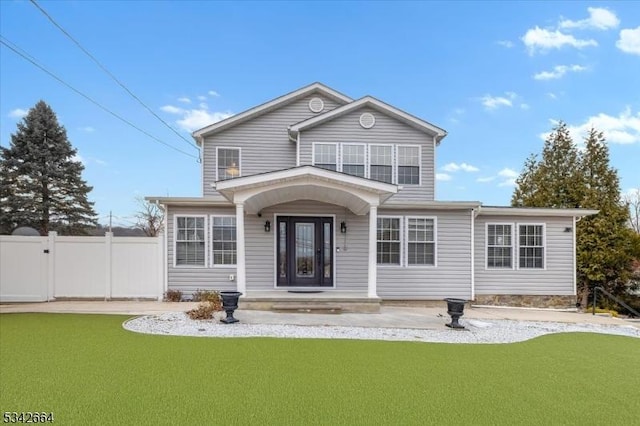 back of house featuring a yard, fence, and a gate