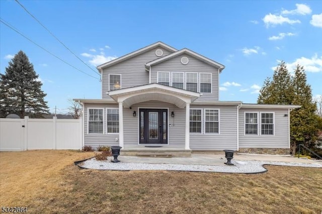 view of front of house featuring a gate, fence, and a front lawn