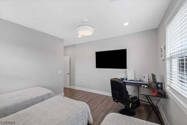 bedroom with baseboards, wood finished floors, and recessed lighting