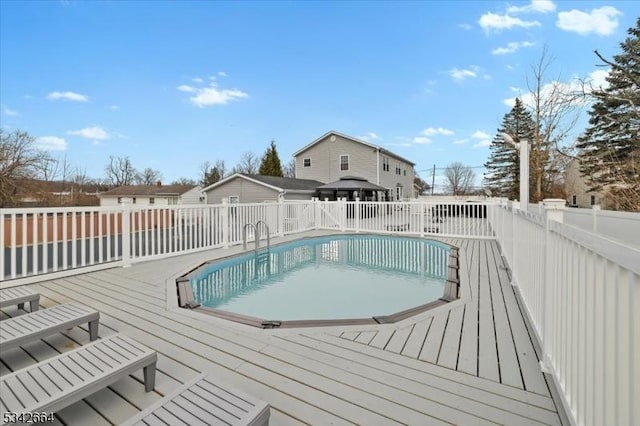 view of swimming pool featuring a fenced in pool, fence, and a wooden deck