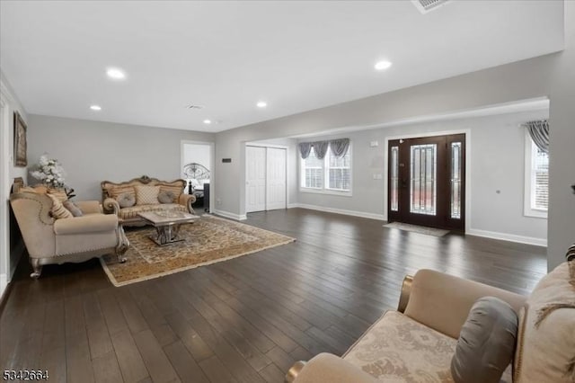 living room with a wealth of natural light, dark wood finished floors, baseboards, and recessed lighting