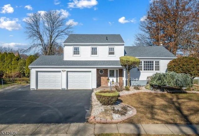 traditional-style home featuring a porch, driveway, and a shingled roof