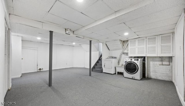 finished basement with a drop ceiling and stairway