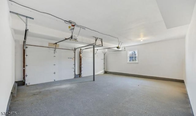 garage with baseboards and a garage door opener