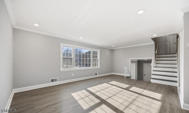 unfurnished living room featuring visible vents, wood finished floors, stairway, crown molding, and baseboards